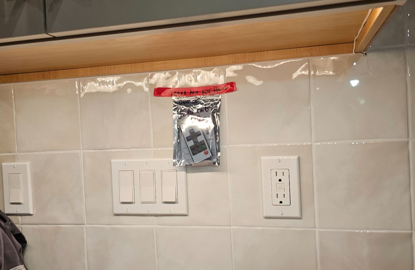 New dimmer switches and GFCI receptacle installed on a kitchen tile backsplash in Vancouver, WA