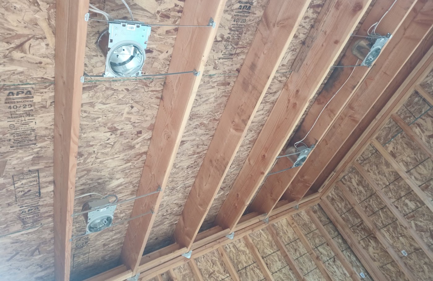 Recessed can lights and ceiling boxes roughed in on open joists in a Vancouver, WA garage