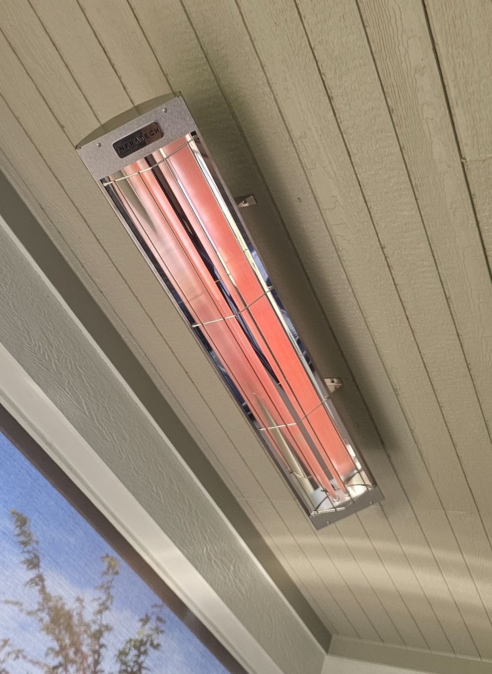 Infratech electric patio heater mounted and running under a Vancouver, WA porch ceiling